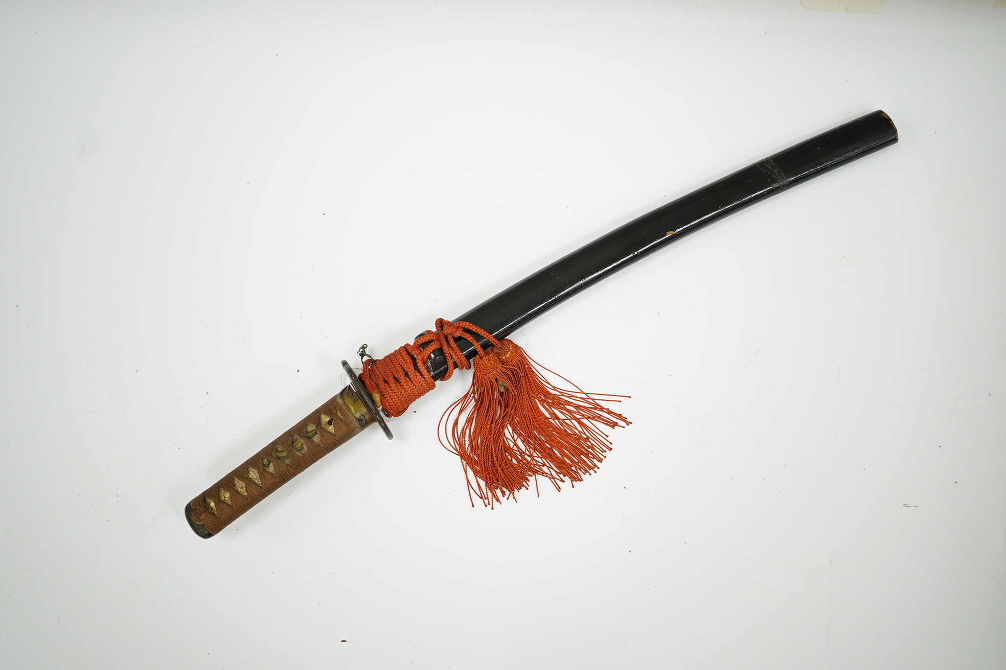 A 19th century Japanese sword wakizashi, blade 39.9cms, signed, iron Sukashi Tsuba of moko form, tape bound same tsuka with brass mounts, in its black lacquered saya. Condition - fair